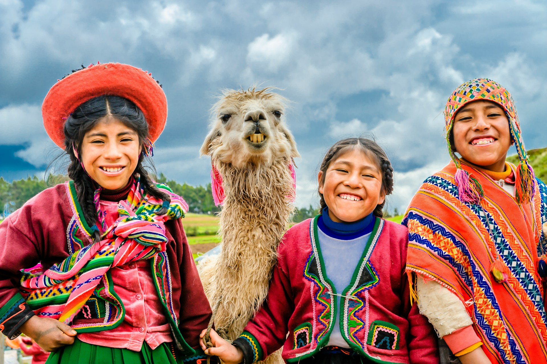 Smilling faces with llama, Cusco Peru. Photo credit Alexander Schimmeck
